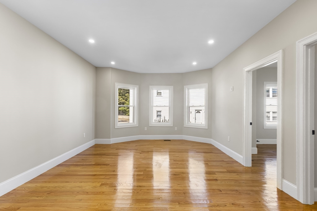 31 Woodale Avenue, Unit 1 Boston, MA 02126 - Photo 5 of 22 a view of empty room with wooden floor