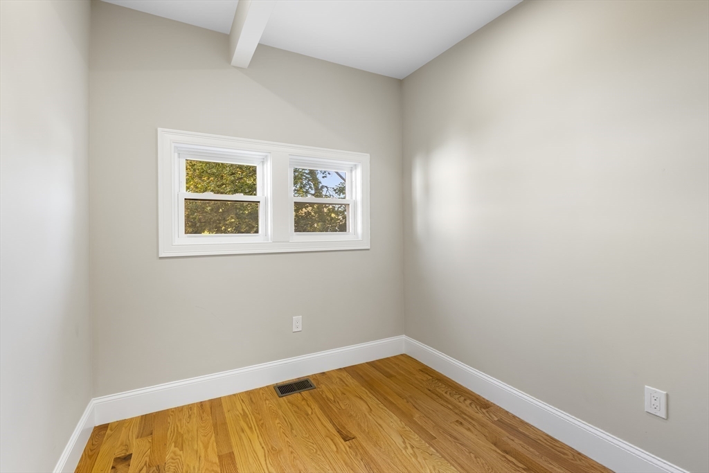31 Woodale Avenue, Unit 1 Boston, MA 02126 - Photo 9 of 22 a view of a room with wooden floor and a window