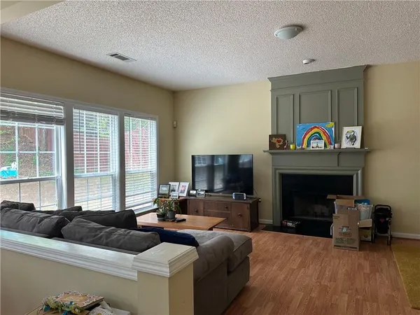 a living room with furniture and a fireplace