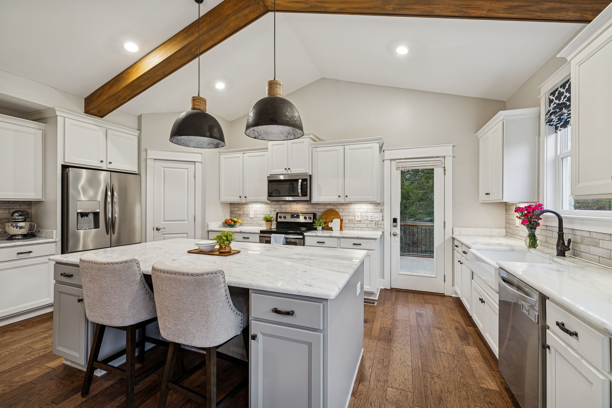 238 Caroline Way Mount Juliet, TN 37122 - Photo 16 of 51 a kitchen with stainless steel appliances granite countertop a kitchen island hardwood floor sink stove dining table and chairs