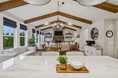 a living room with furniture and book shelf
