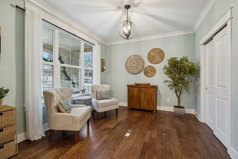a dining room with furniture and wooden floor