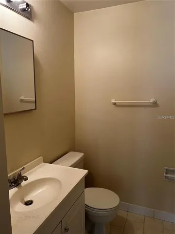 a bathroom with a sink a toilet and mirror