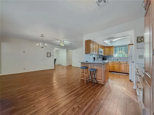 a view of kitchen with sink microwave and cabinets