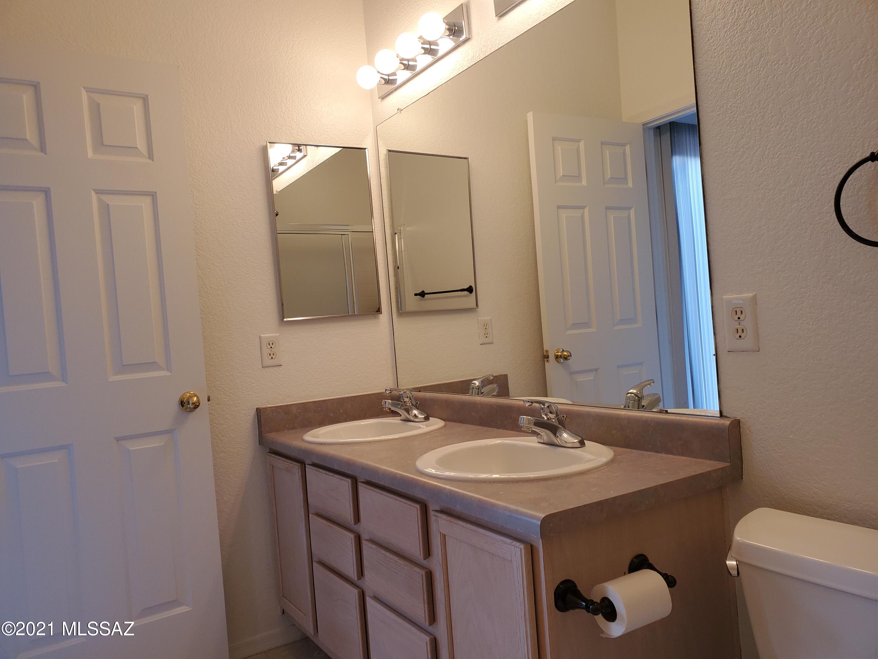 3455 North Boyce Spring Lane Tucson, AZ 85745 - Photo 17 of 21 a bathroom with a sink and a mirror