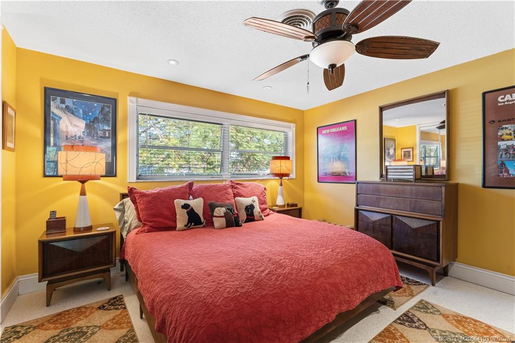 900 Northwest 11th Terrace Stuart, FL 34994 - Photo 13 of 35 a bedroom with a bed and wooden floor