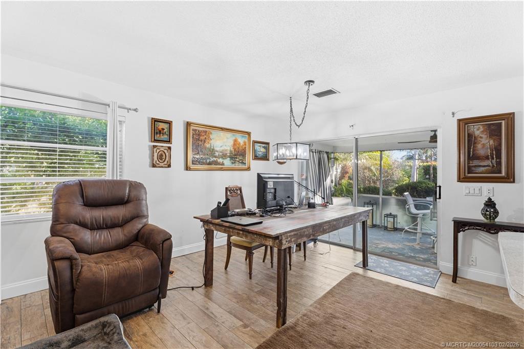 900 Northwest 11th Terrace Stuart, FL 34994 - Photo 19 of 35 a work room with furniture and wooden floor