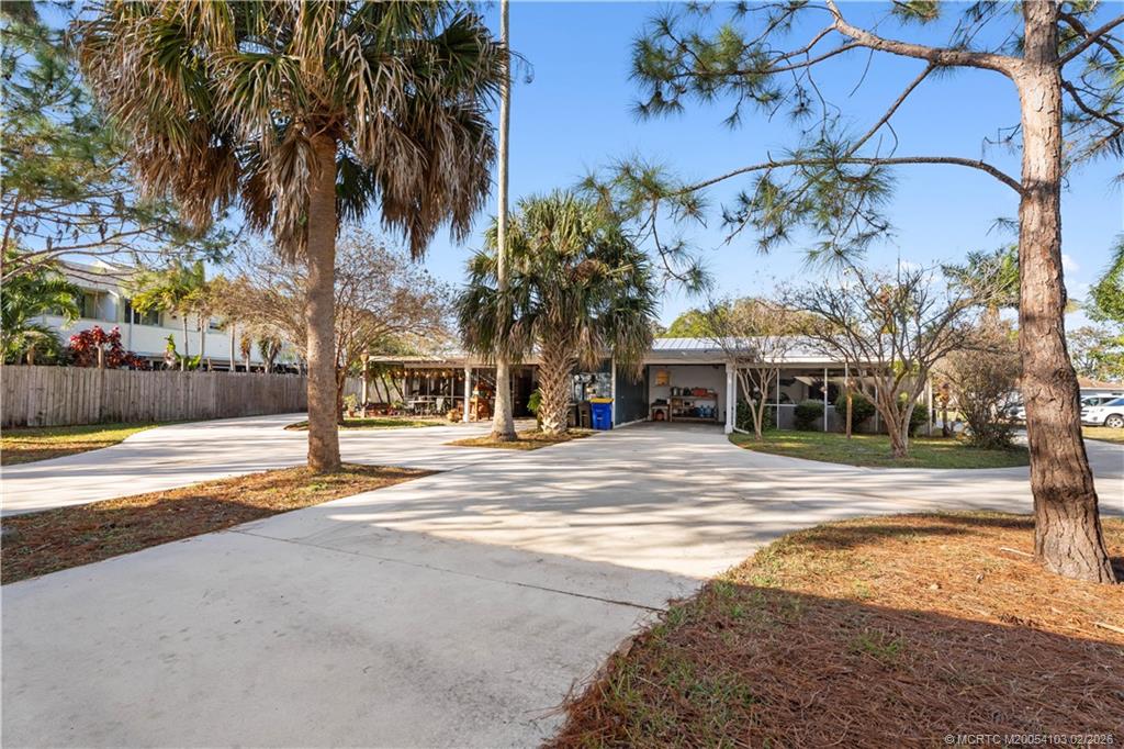 900 Northwest 11th Terrace Stuart, FL 34994 - Photo 27 of 35 a view of a house with a yard and tree s