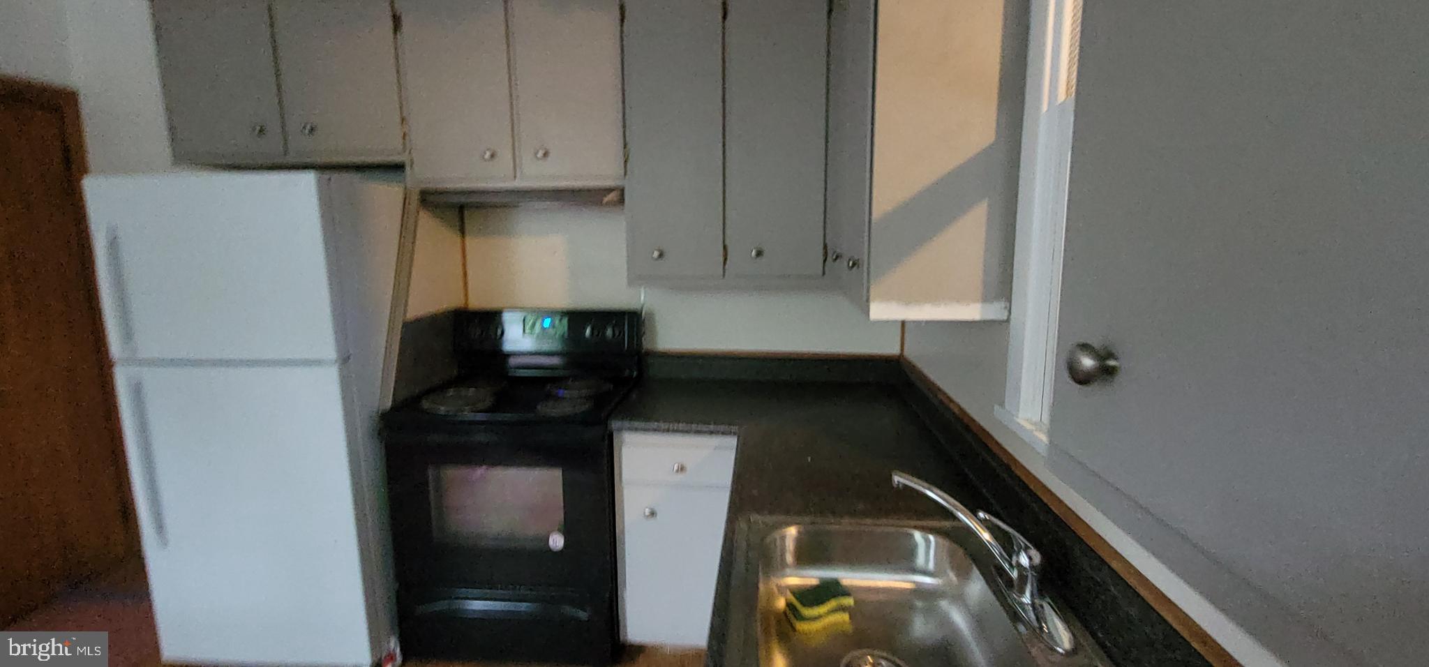324 Spring Street, Unit 1 Reading, PA 19601 - Photo 37 of 45 a kitchen with a refrigerator and a stove