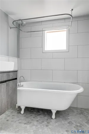 a bathroom with a bathtub and a shower