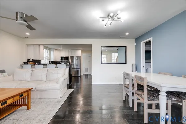 a living room with furniture and kitchen view