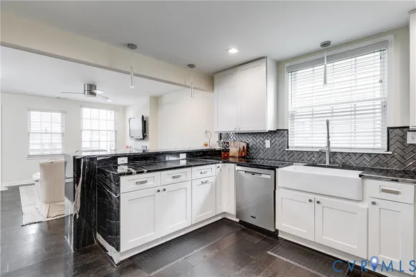 a kitchen with granite countertop white cabinets and white appliances
