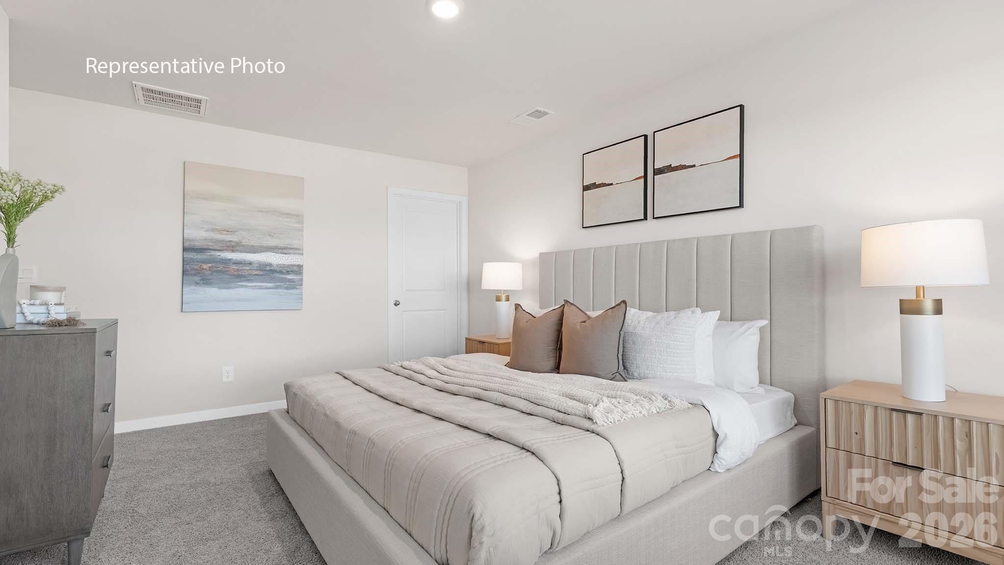 107 Parmiter Way, Unit B Troutman, NC 28166 - Photo 16 of 22 a bedroom with a bed and a night stand