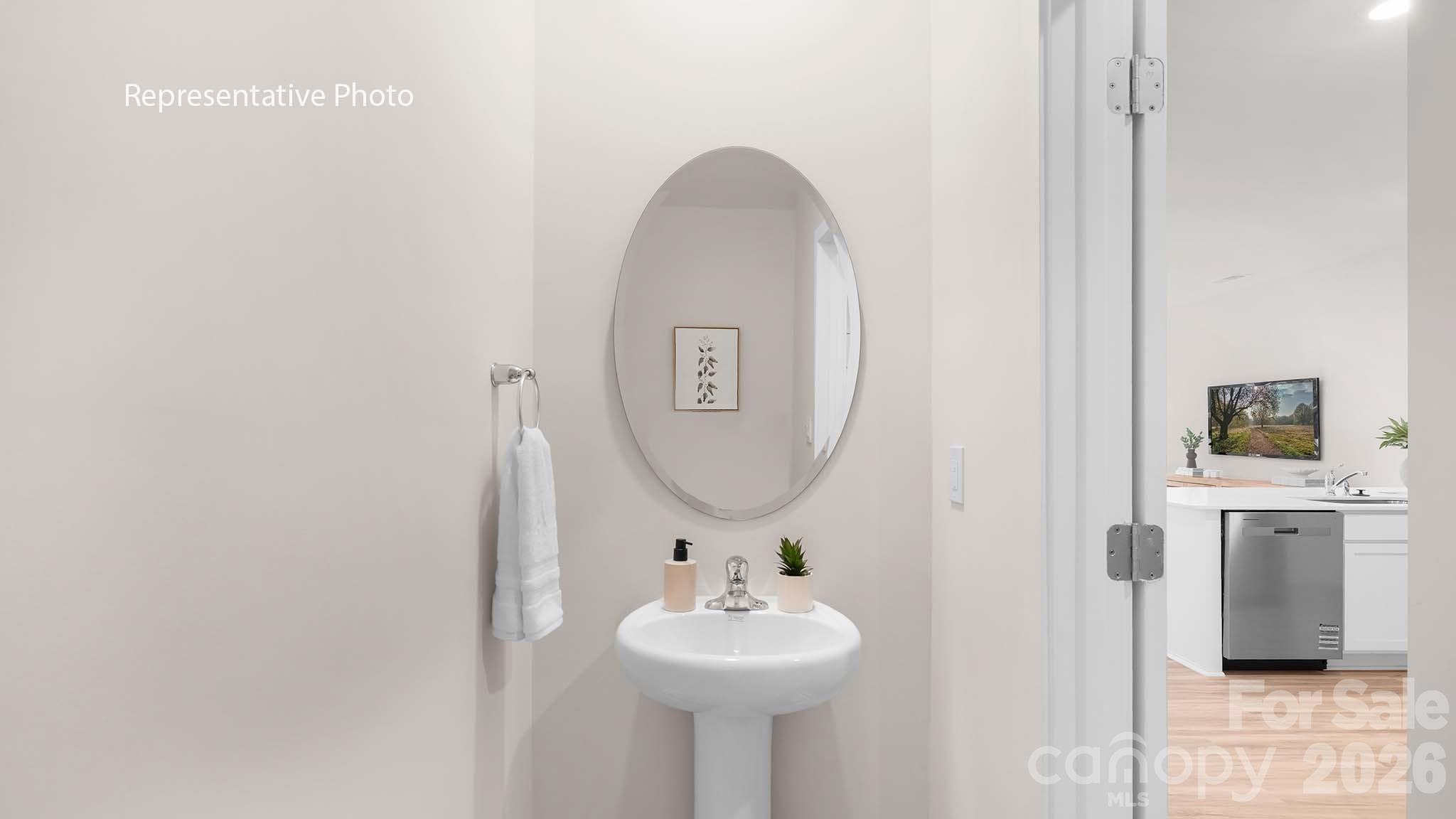 107 Parmiter Way, Unit B Troutman, NC 28166 - Photo 3 of 22 a bathroom with a sink and a mirror