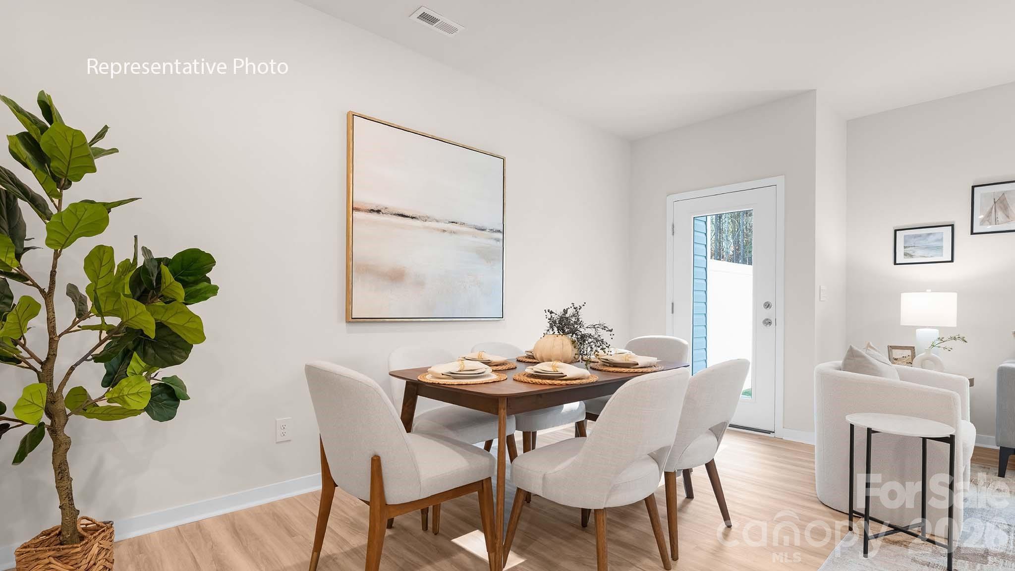 107 Parmiter Way, Unit B Troutman, NC 28166 - Photo 7 of 22 a view of a dining room with furniture and wooden floor