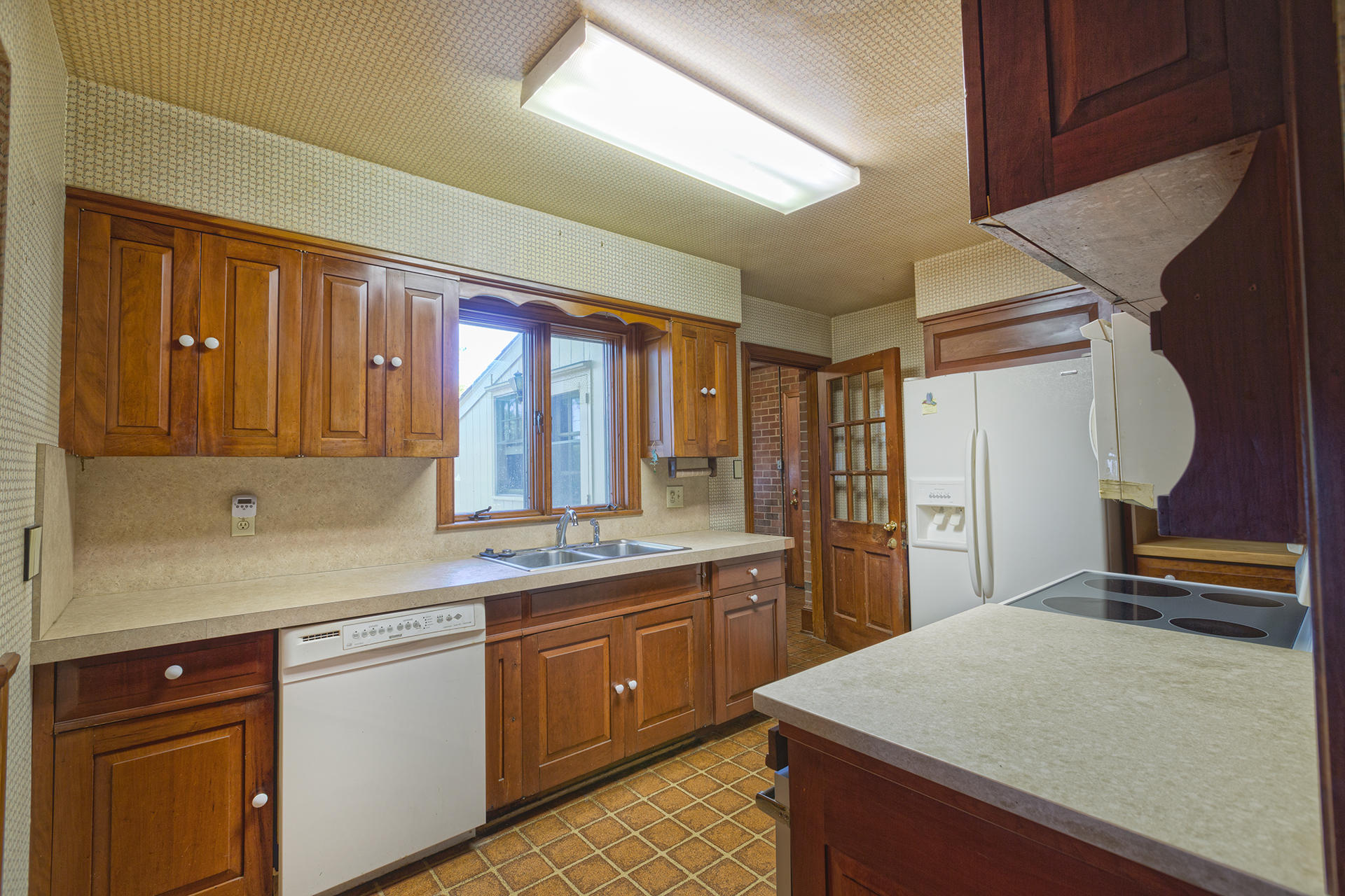 3434 West Ridge Circle Southwest Roanoke, VA 24014 - Photo 13 of 37 a kitchen with a sink a stove cabinets and a wooden floor