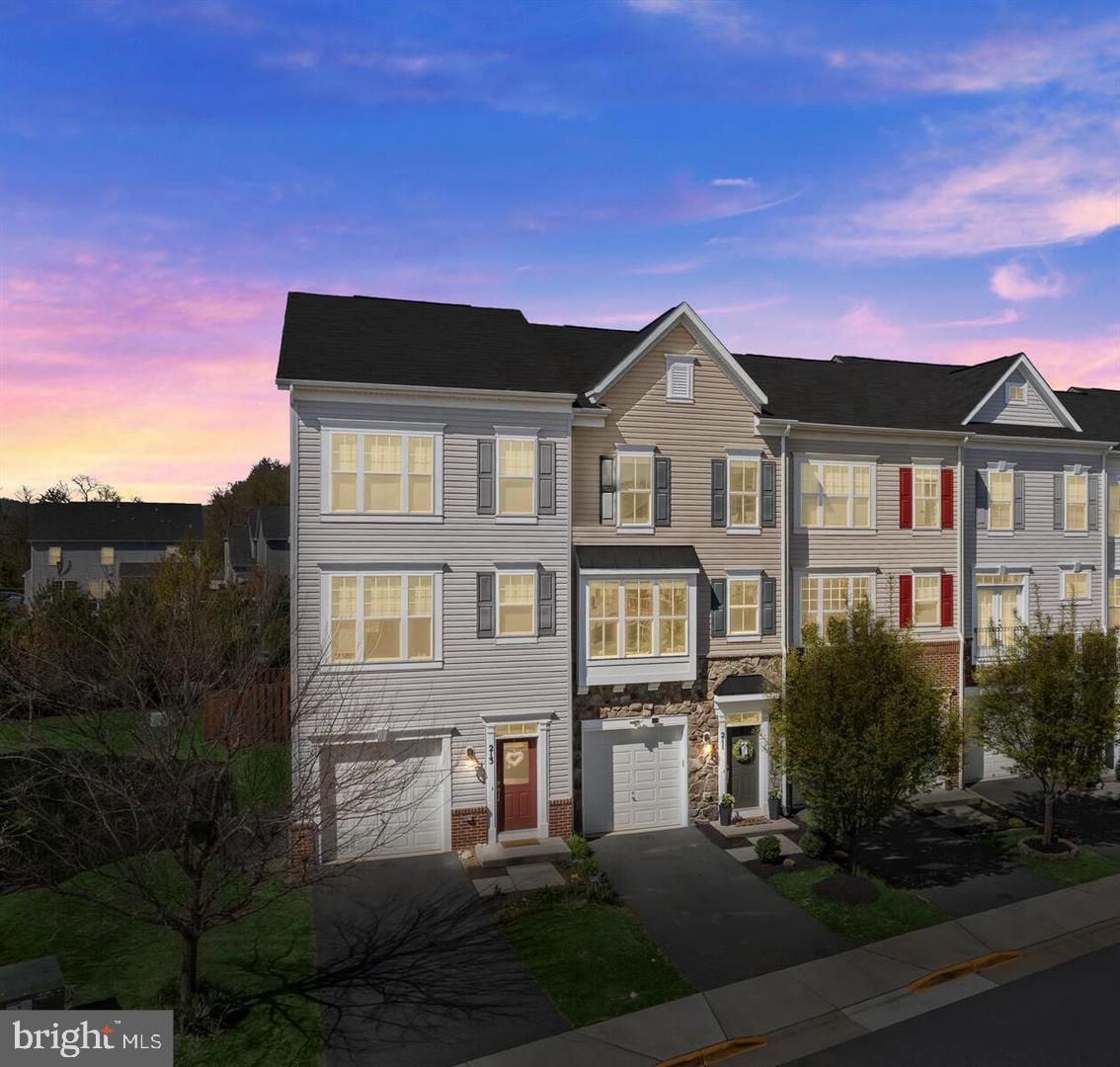 Charming townhouse with vibrant sunset backdrop.