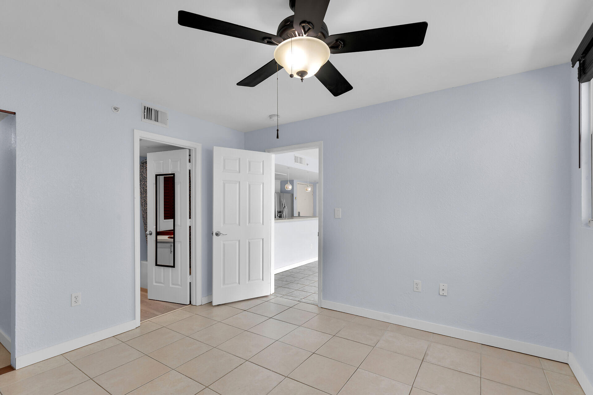 3635 Seaside Drive, Unit 206 Key West, FL 33040 - Photo 15 of 30 an empty room with closet and a chandelier fan