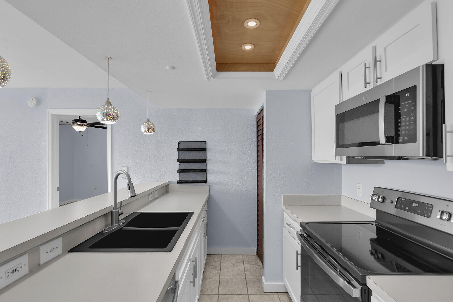 3635 Seaside Drive, Unit 206 Key West, FL 33040 - Photo 6 of 30 a kitchen with granite countertop a sink and stainless steel appliances