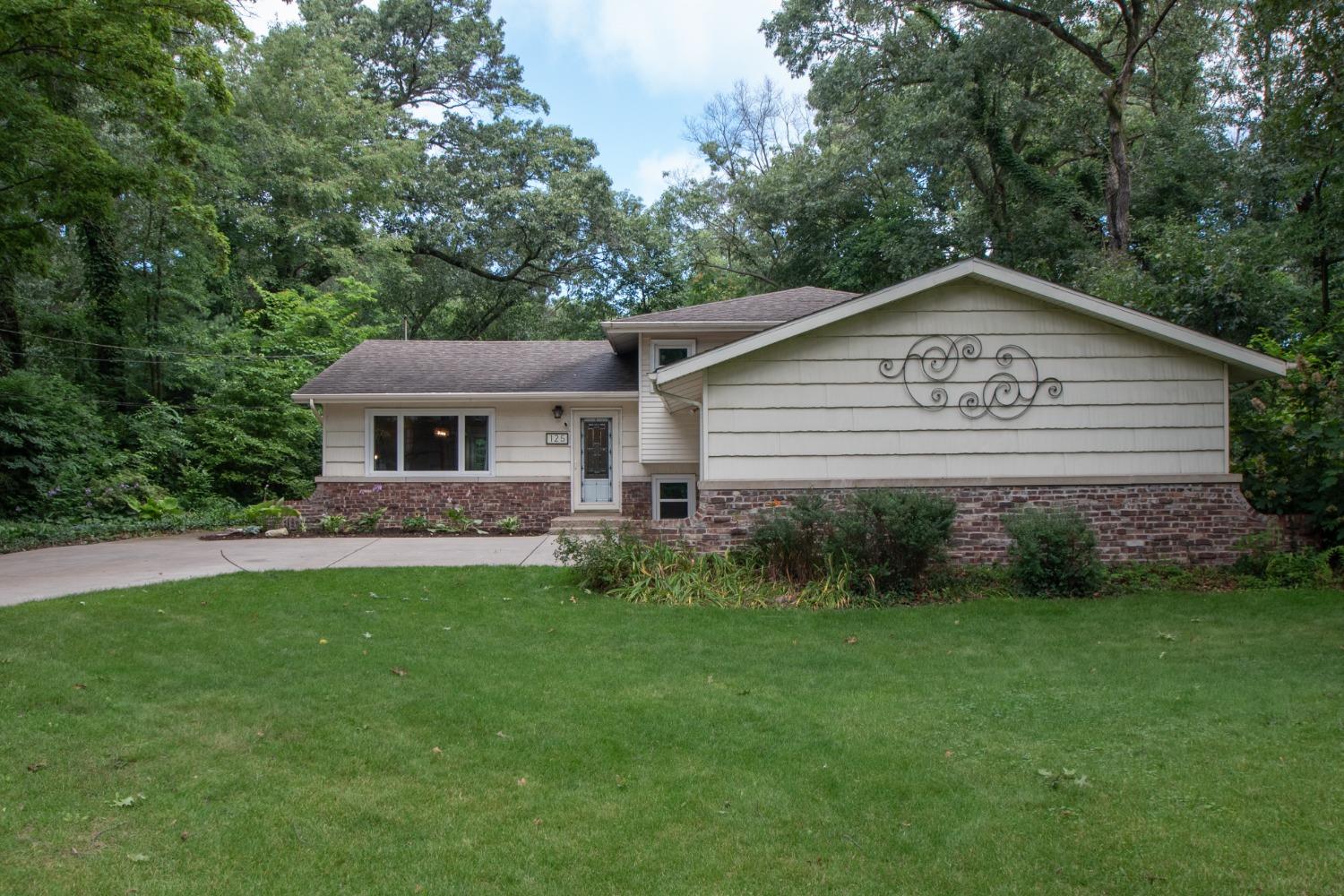 a view of a house with a yard and a garden