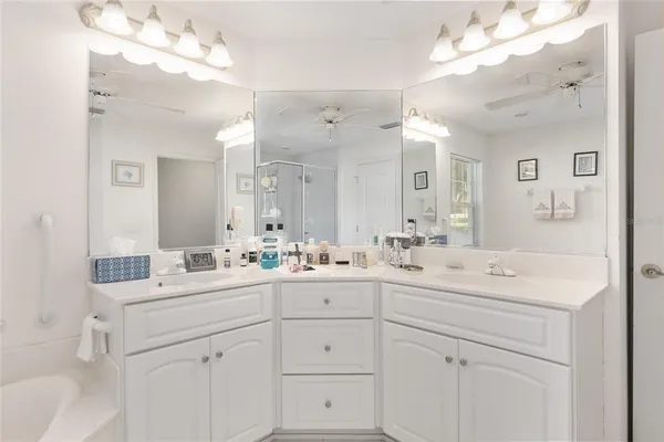 a spacious bedroom with two bed and a chandelier