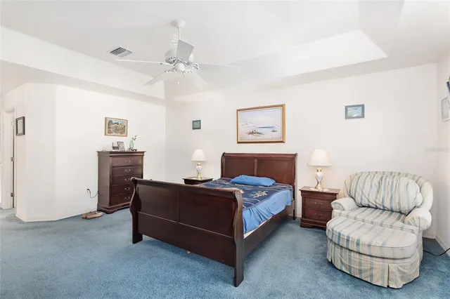 a view of a bedroom with wooden floor and bathroom