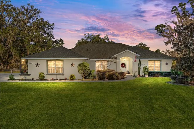a front view of a house with a garden and porch