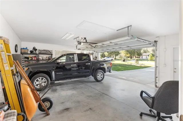 a kitchen with kitchen island granite countertop a sink and cabinets
