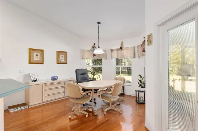 a front view of a house with garden and trees