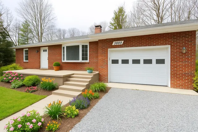 a front view of a house with a yard and potted plants