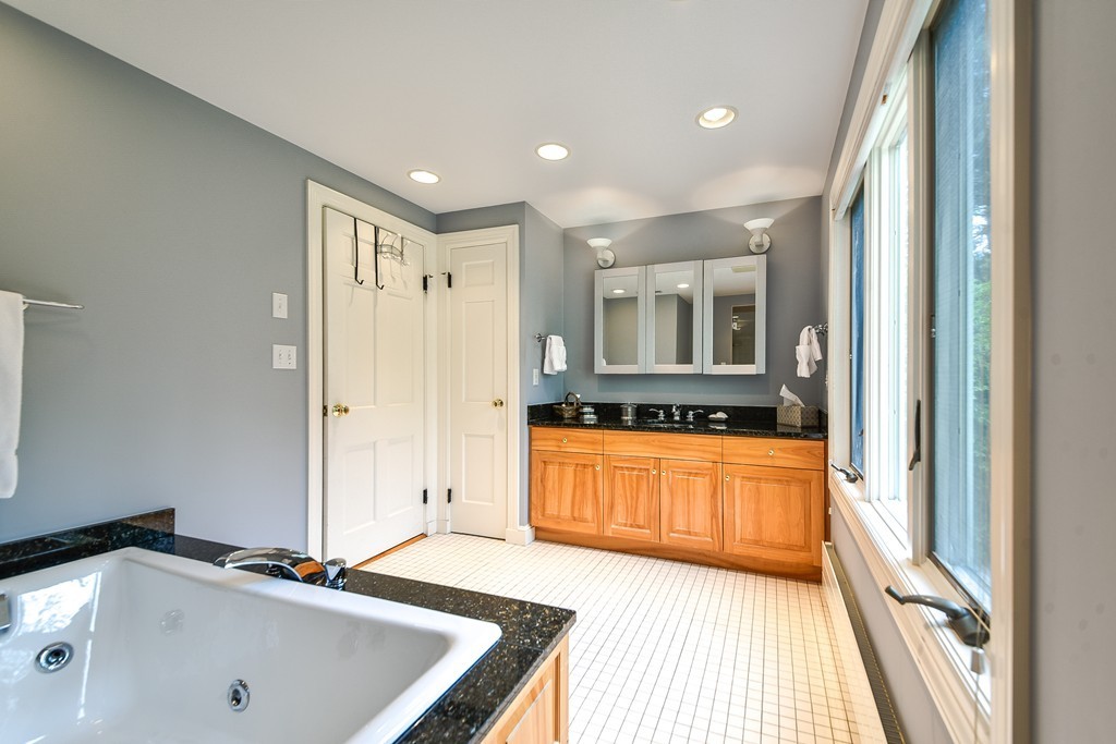 3 Woodfield Road Wellesley, MA 02482 - Photo 13 of 23 a bathroom with a tub a sink and a large mirror