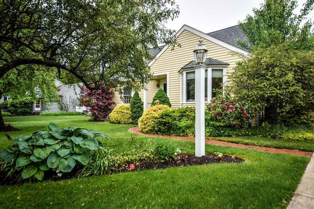 3 Woodfield Road Wellesley, MA 02482 - Photo 21 of 23 a white house that has a small yard and large trees