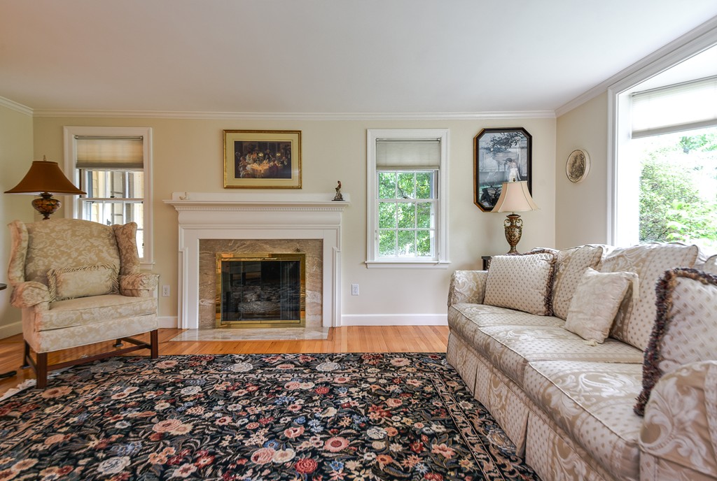 3 Woodfield Road Wellesley, MA 02482 - Photo 3 of 23 a living room with a couch and a fireplace