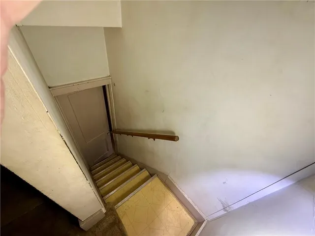 an empty room with a chandelier fan