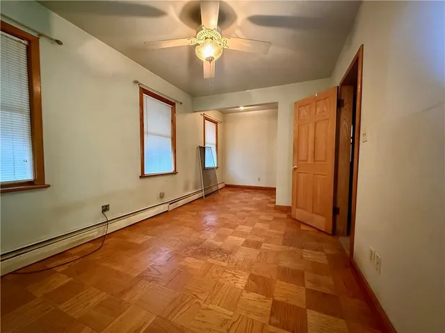 a view of a room with a wooden floor and windows
