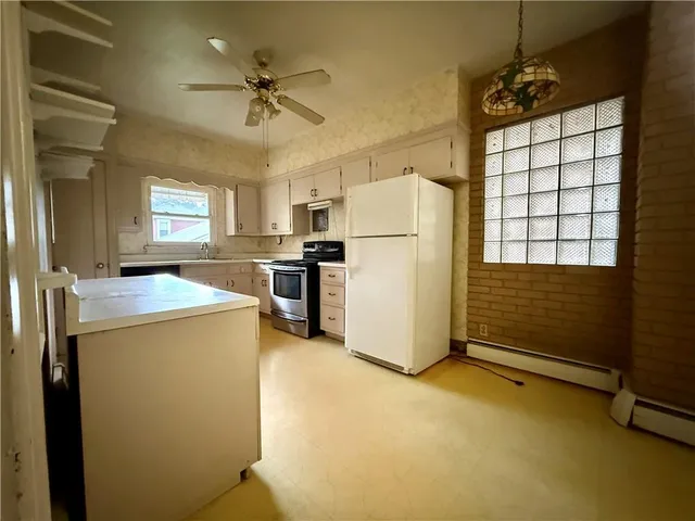 a view of a livingroom with wooden floor and a window