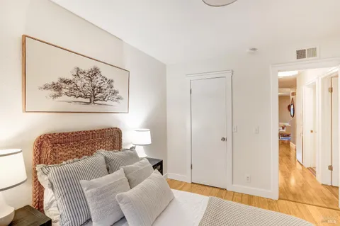 a living room with furniture and a painting on the wall