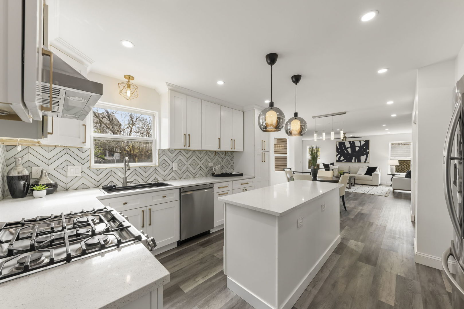 138 Chestnut Lane Bolingbrook, IL 60490 - Photo 5 of 26 a large kitchen with stainless steel appliances a stove a sink dishwasher and a dining table with wooden floor