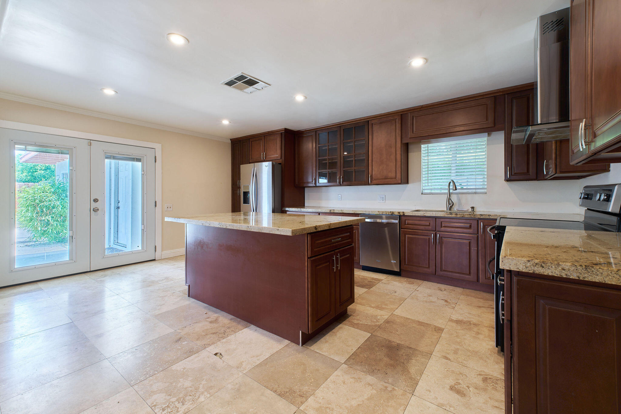 83175 Rue Paray Thermal, CA 92274 - Photo 11 of 44 a large kitchen with stainless steel appliances granite countertop a sink counter space cabinets and a large window