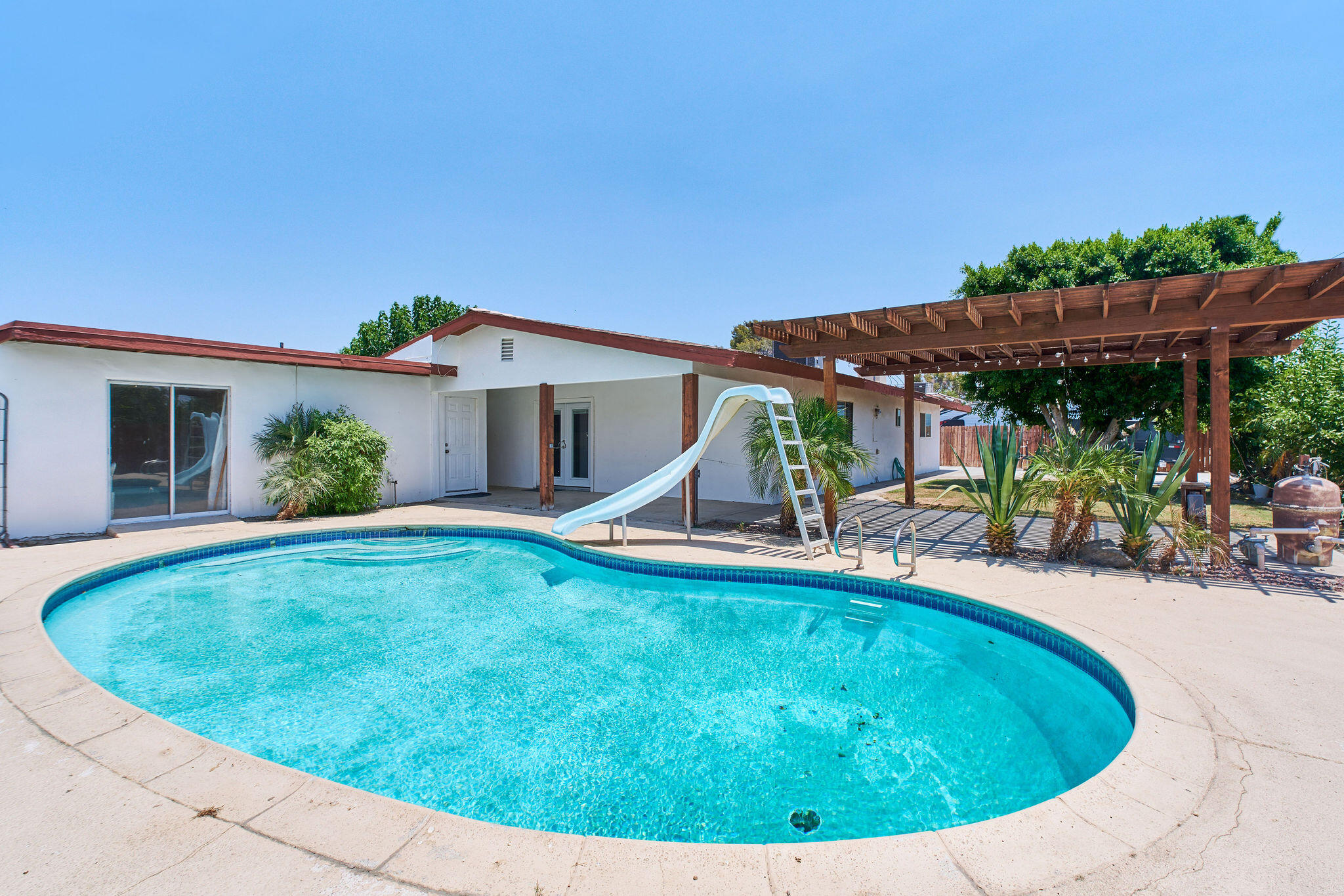 83175 Rue Paray Thermal, CA 92274 - Photo 14 of 44 a view of a house with pool fire pit a patio and a yard