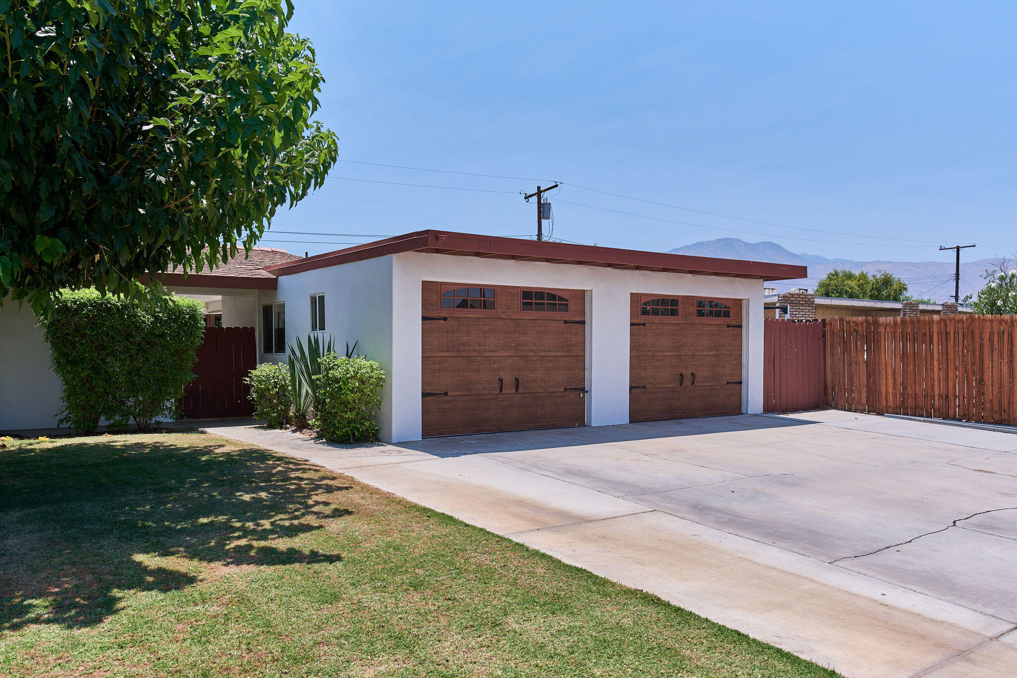 83175 Rue Paray Thermal, CA 92274 - Photo 2 of 44 a front view of a house with a yard and garage