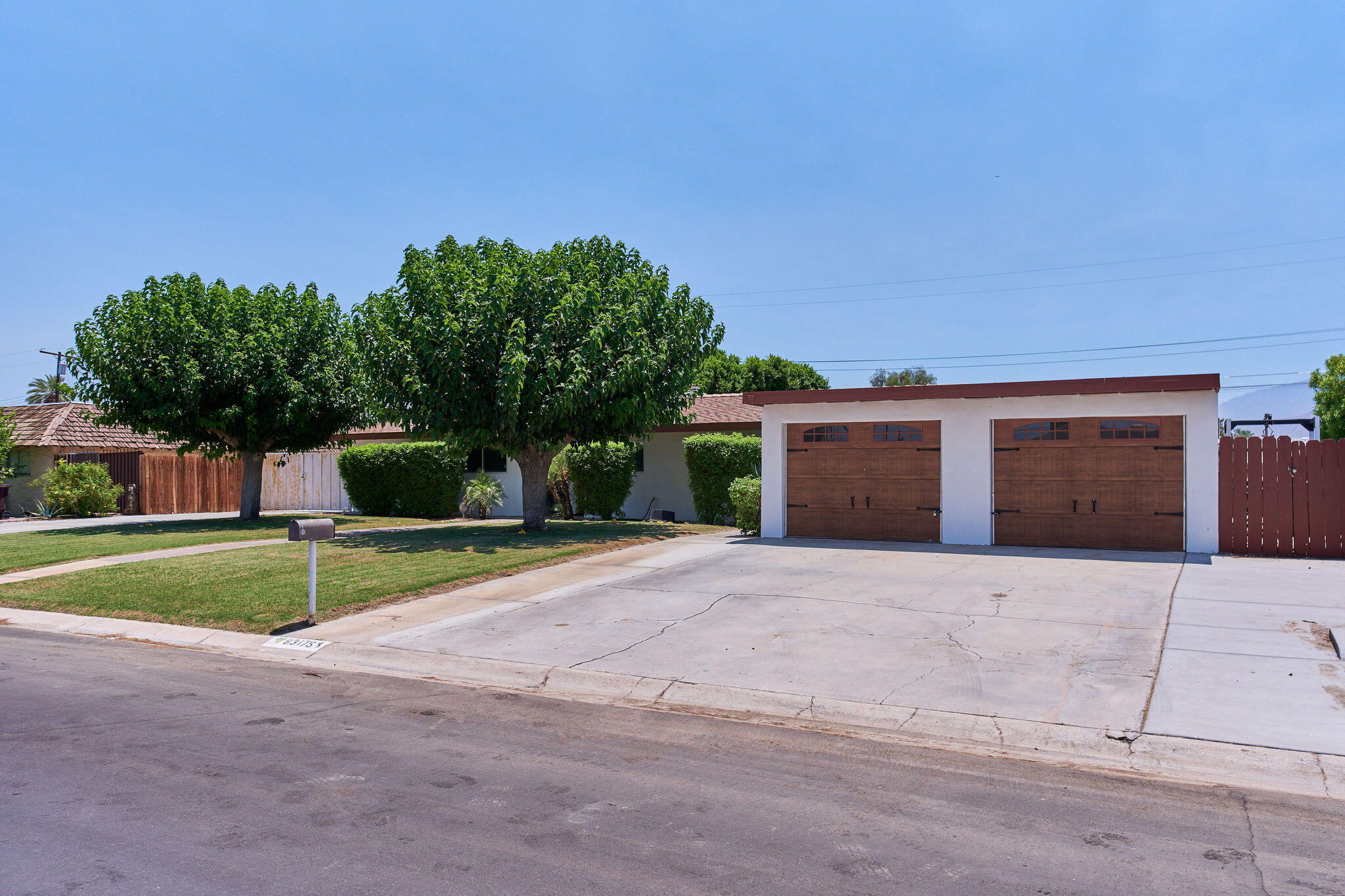 83175 Rue Paray Thermal, CA 92274 - Photo 3 of 44 a front view of a house with a yard and garage