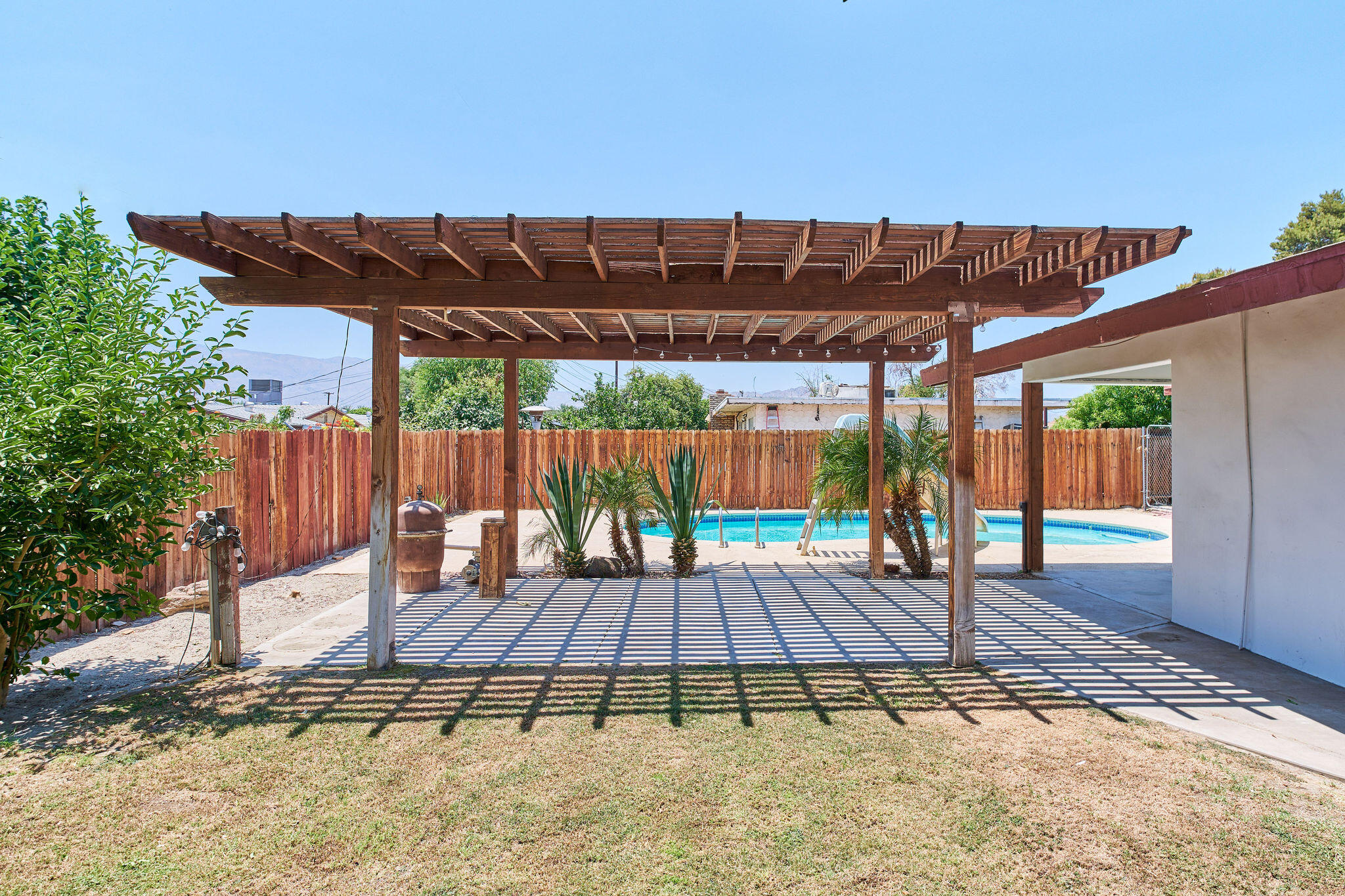 83175 Rue Paray Thermal, CA 92274 - Photo 6 of 44 a wooden bench sitting in front of a building