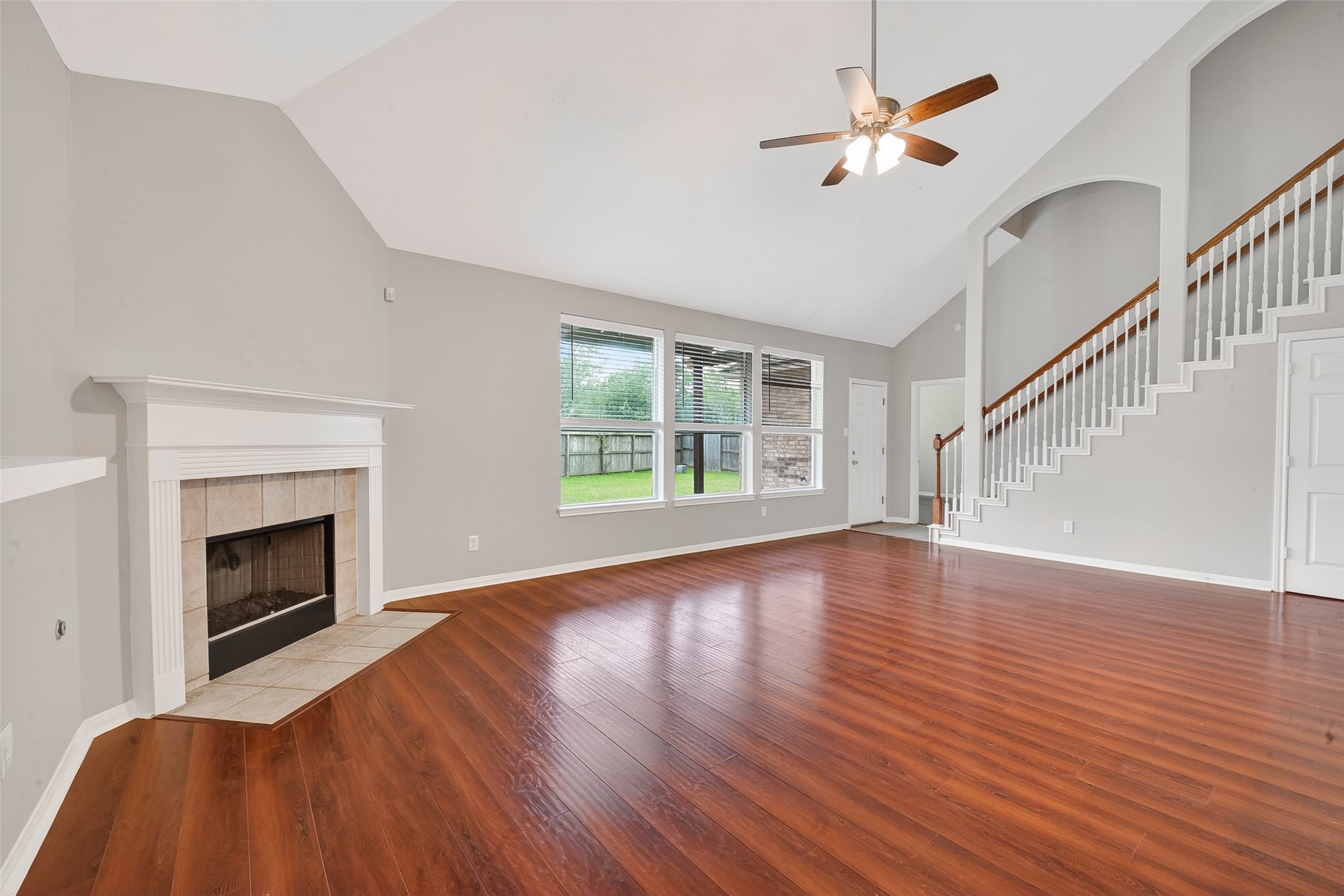14308 Rocky Briar Lane Rosharon, TX 77583 - Photo 18 of 46 a view of an empty room with wooden floor fireplace and a window