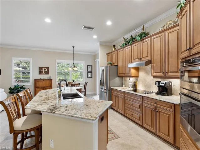 a kitchen with granite countertop a sink and cabinets