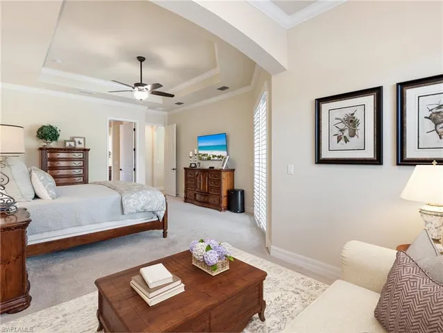 a bedroom with a bed furniture and a chandelier