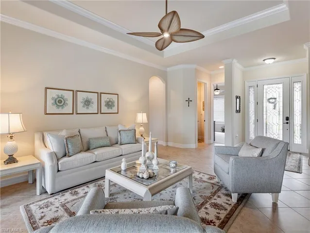 a living room with furniture a rug and a chandelier