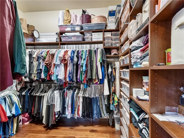 a view of walk in closet with clothes