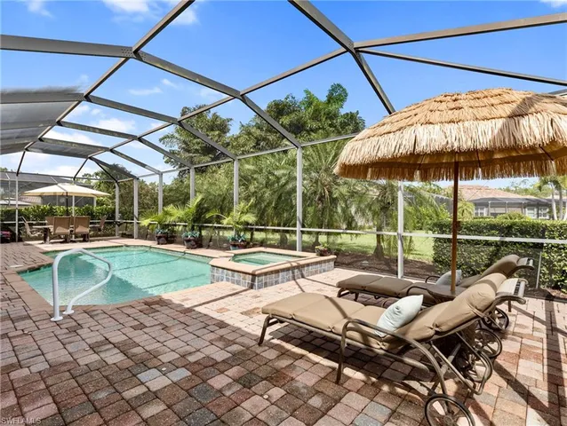 a view of a patio with a table and chairs under an umbrella