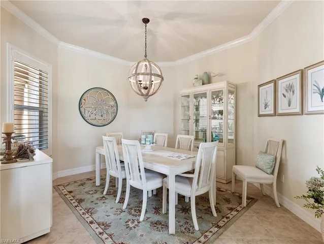 a view of a dining room with furniture a chandelier and wooden floor